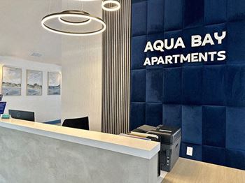 Lobby with a reception desk at Aqua Bay Apartments in Naples, FL 34116